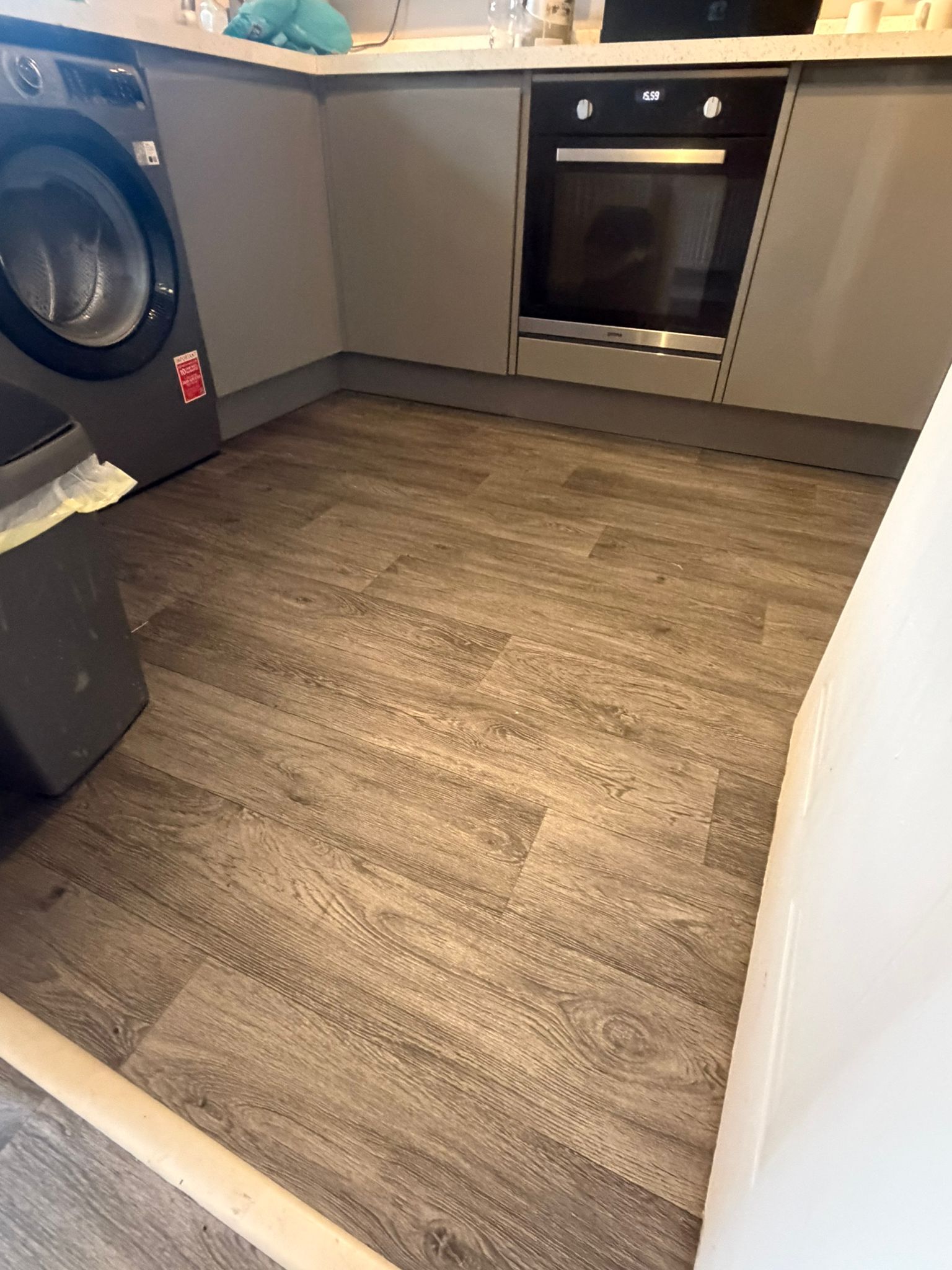 Wood effect vinyl flooring fitted in kitchen