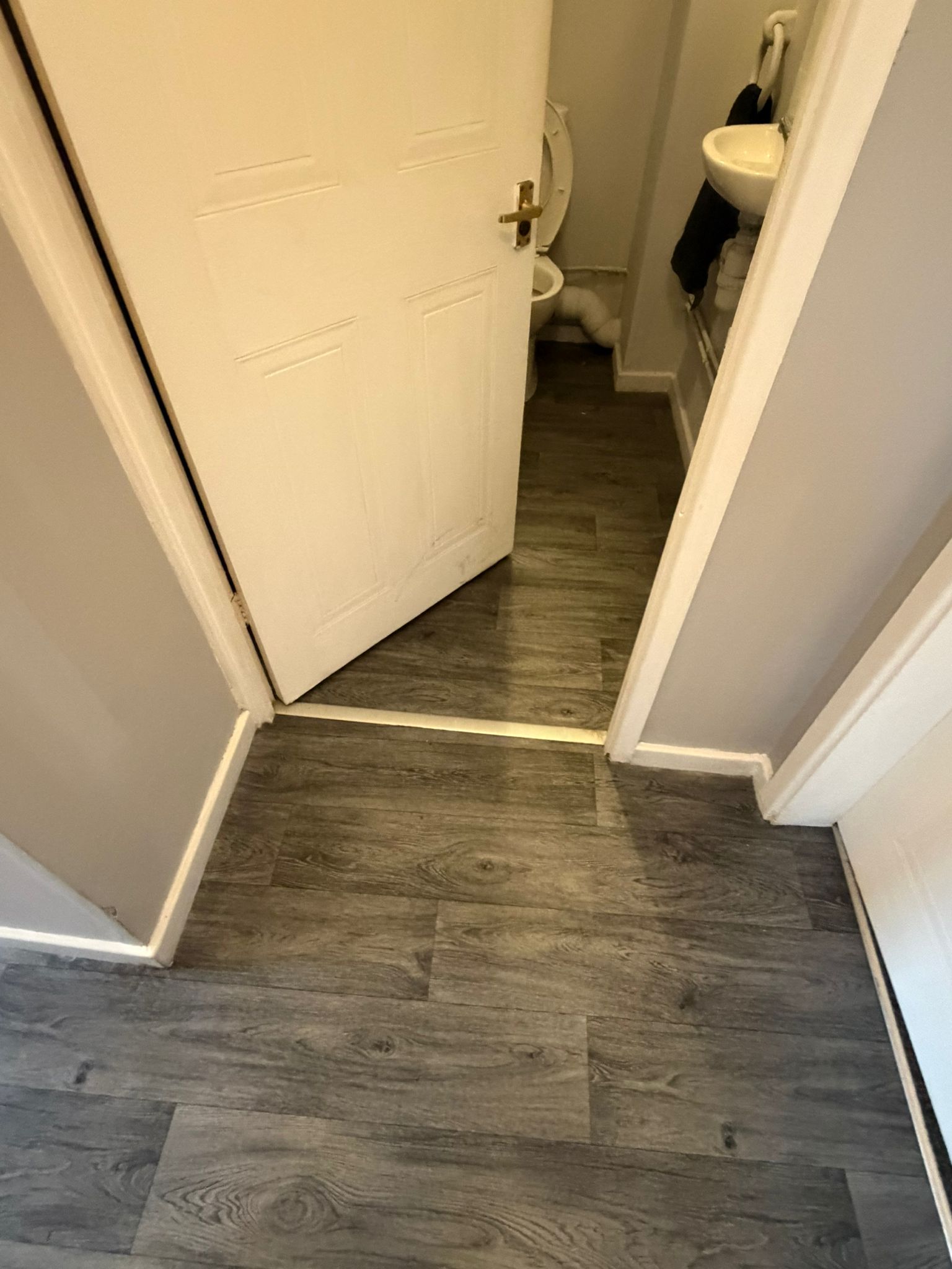 Wood effect vinyl flooring fitted in hallway and bathroom area